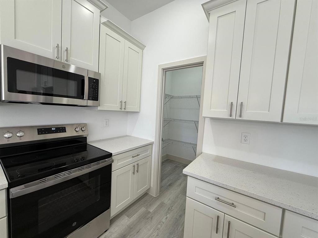 3057 Aliceville Road North Port, FL 34288 - Photo 14 of 33 a kitchen with a stove and a microwave