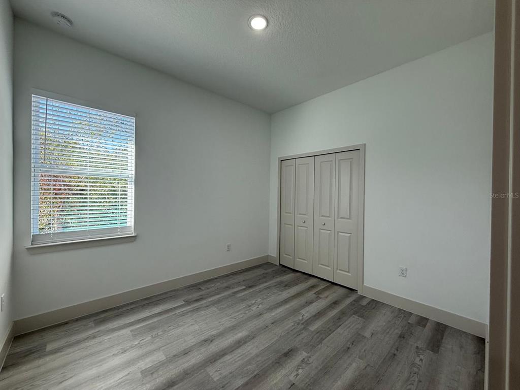 3057 Aliceville Road North Port, FL 34288 - Photo 17 of 33 an empty room with wooden floor and windows