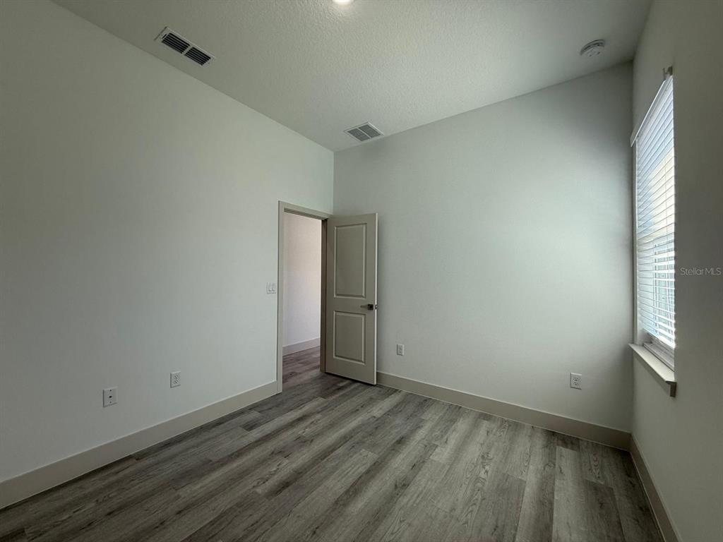 3057 Aliceville Road North Port, FL 34288 - Photo 18 of 33 a view of a room with wooden floor and a window