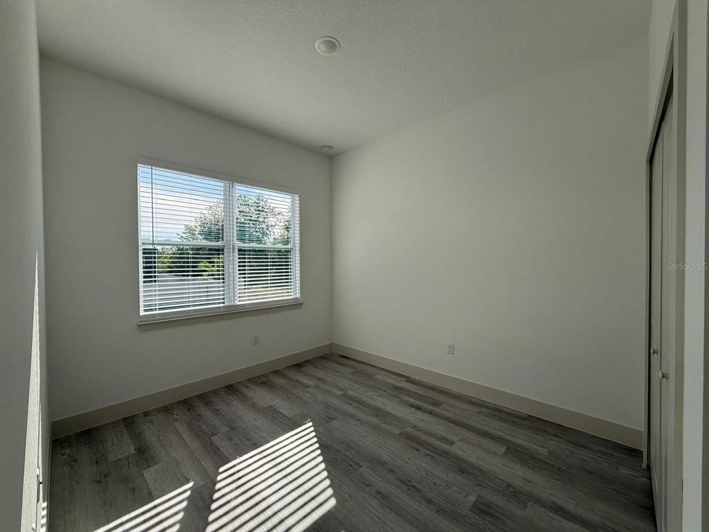 3057 Aliceville Road North Port, FL 34288 - Photo 20 of 33 a view of an empty room with wooden floor and a window