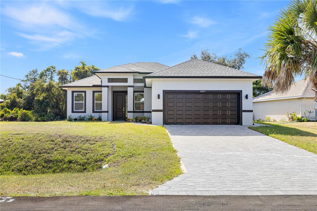 3057 Aliceville Road North Port, FL 34288 - Photo 2 of 33 a front view of a house with yard and parking