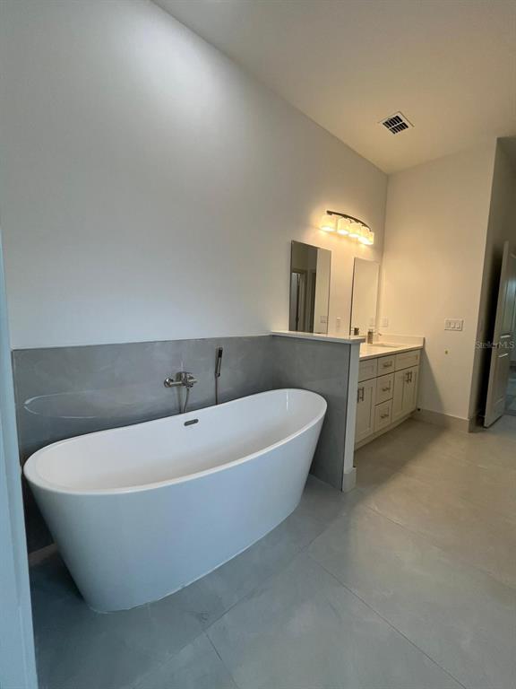 3057 Aliceville Road North Port, FL 34288 - Photo 26 of 33 a white bath tub sitting in a bathroom