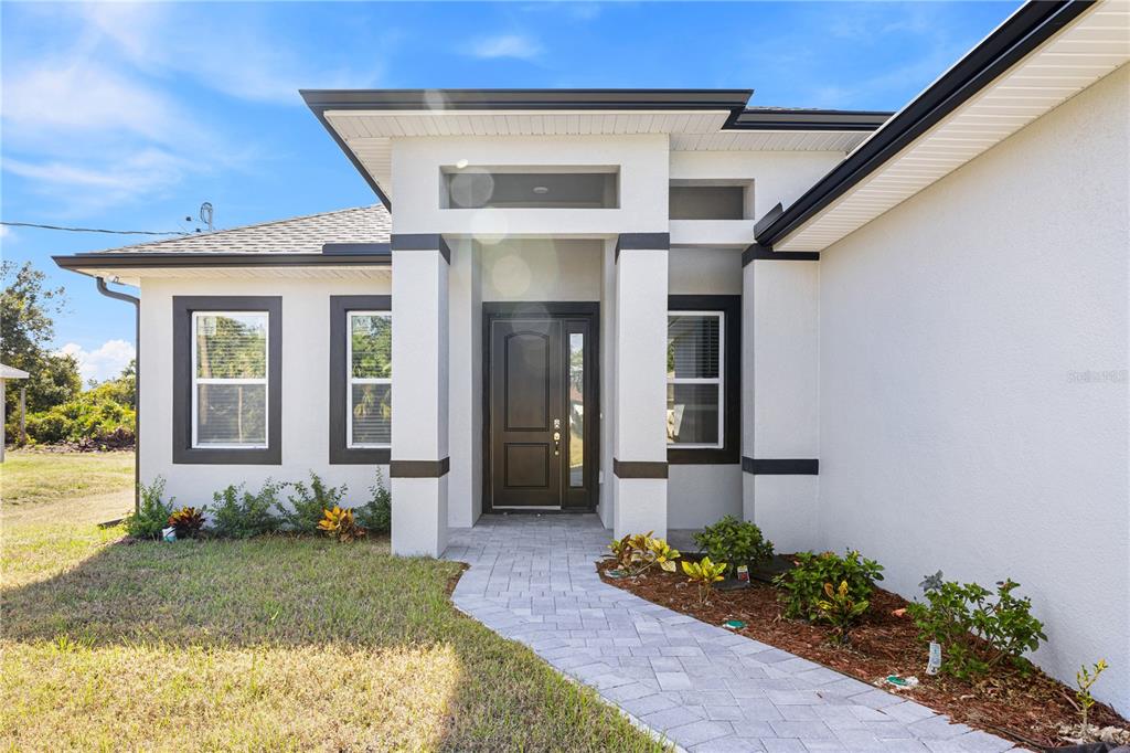 3057 Aliceville Road North Port, FL 34288 - Photo 4 of 33 a front view of a house with garden