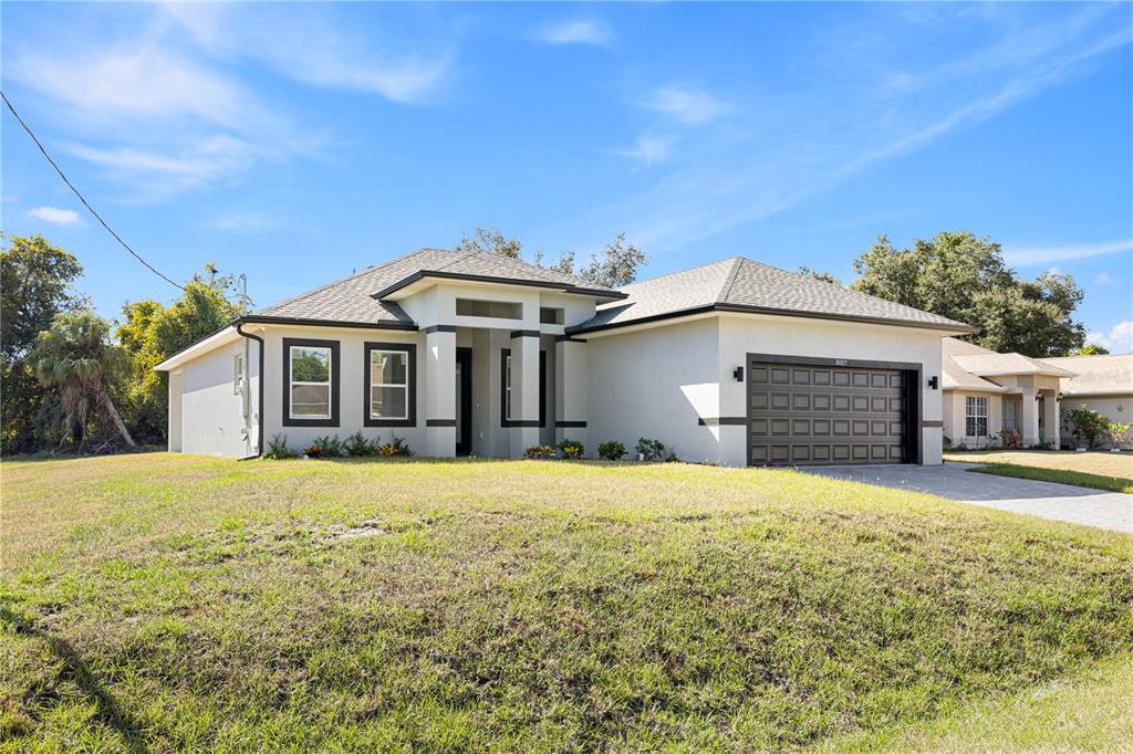 3057 Aliceville Road North Port, FL 34288 - Photo 9 of 33 a front view of a house with a yard