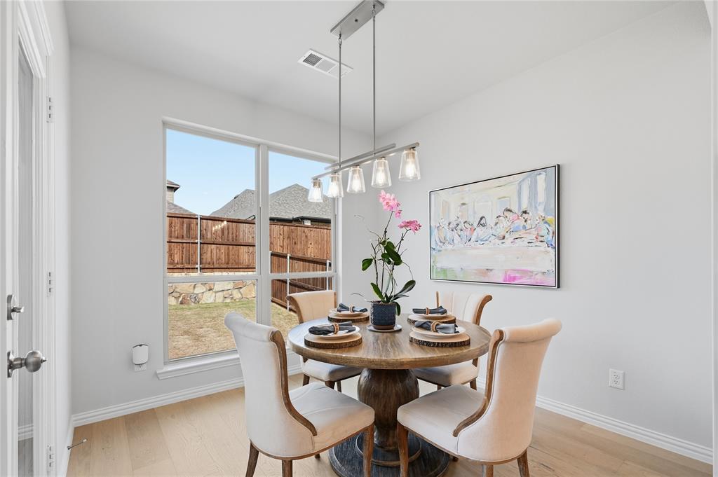 9317 Sunset Lane Oak Point, TX 75068 - Photo 12 of 40 a view of a dining room with furniture and wooden floor