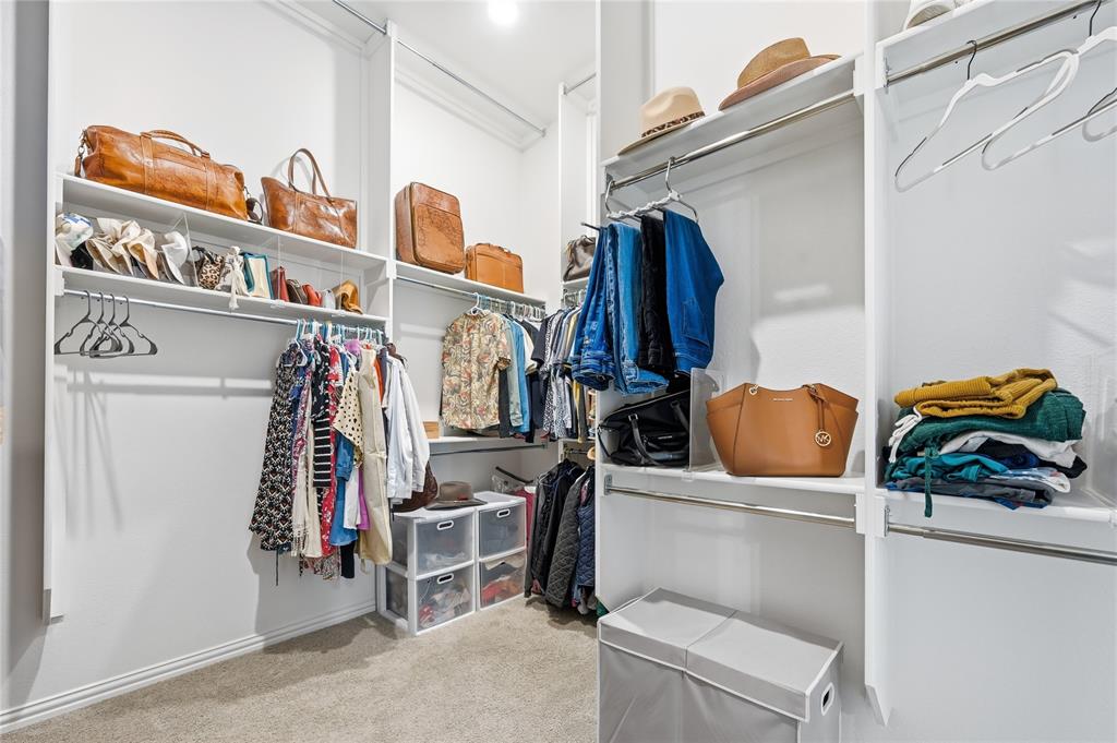 9317 Sunset Lane Oak Point, TX 75068 - Photo 17 of 40 a view of walk in closet with clothes and shoes