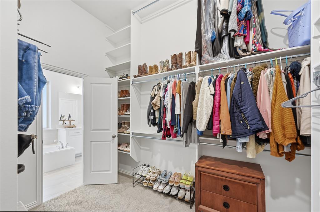 9317 Sunset Lane Oak Point, TX 75068 - Photo 18 of 40 a view of walk in closet with clothes and shoes