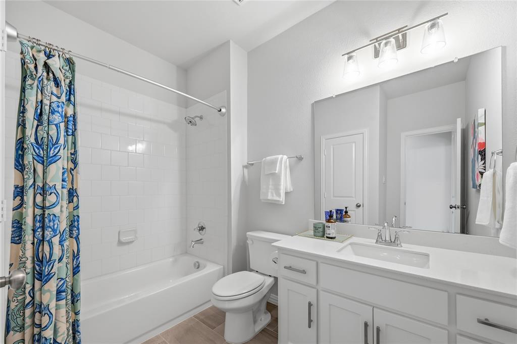 9317 Sunset Lane Oak Point, TX 75068 - Photo 20 of 40 a bathroom with a sink a toilet and shower