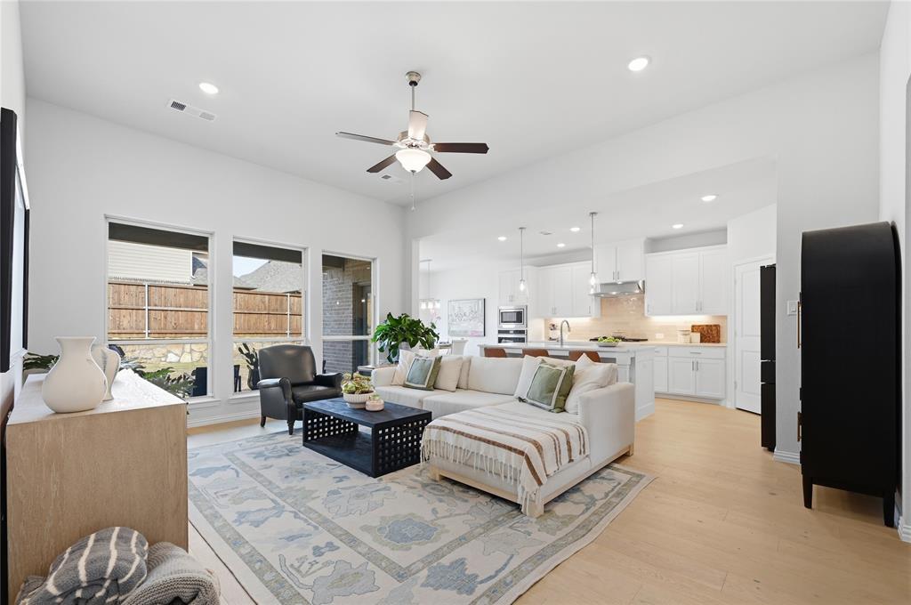9317 Sunset Lane Oak Point, TX 75068 - Photo 2 of 40 a living room with furniture ceiling fan and a large window