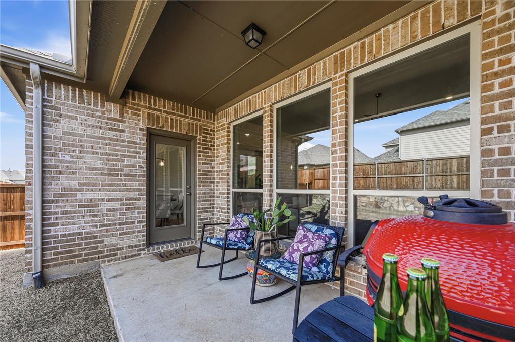9317 Sunset Lane Oak Point, TX 75068 - Photo 25 of 40 a view of a patio with a table and chairs and wooden floor