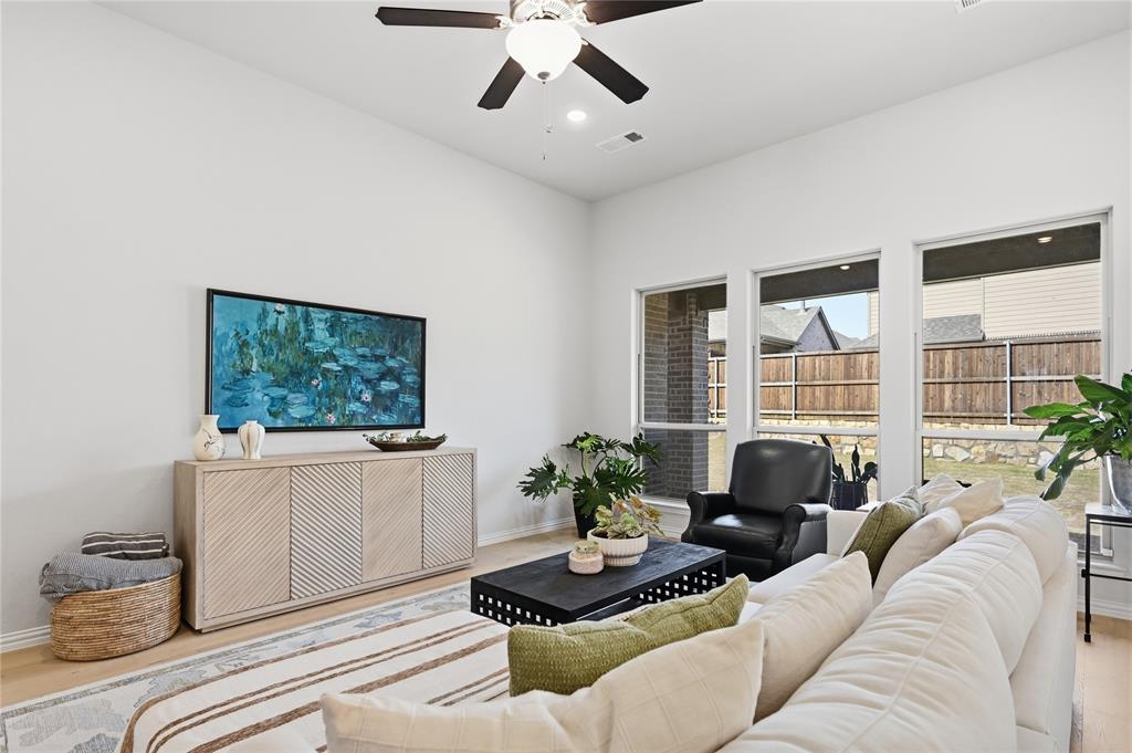 9317 Sunset Lane Oak Point, TX 75068 - Photo 8 of 40 a living room with furniture and a flat screen tv