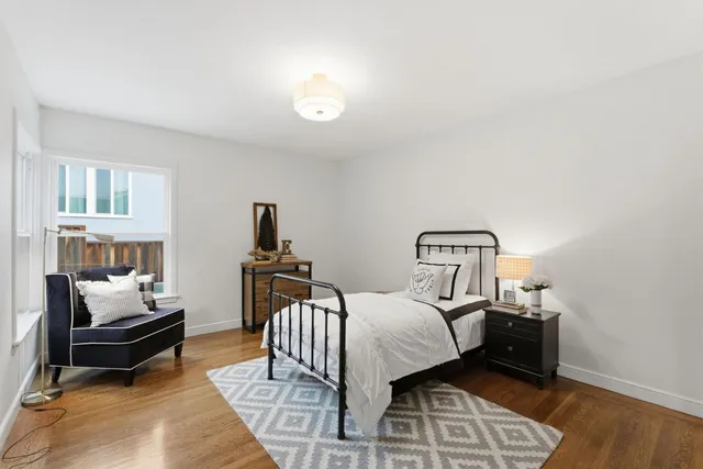 a backyard of a house with table and chairs