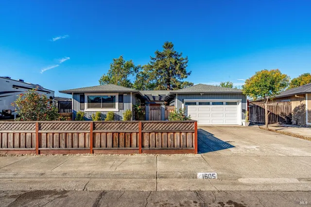 a view of a house with a yard and plants