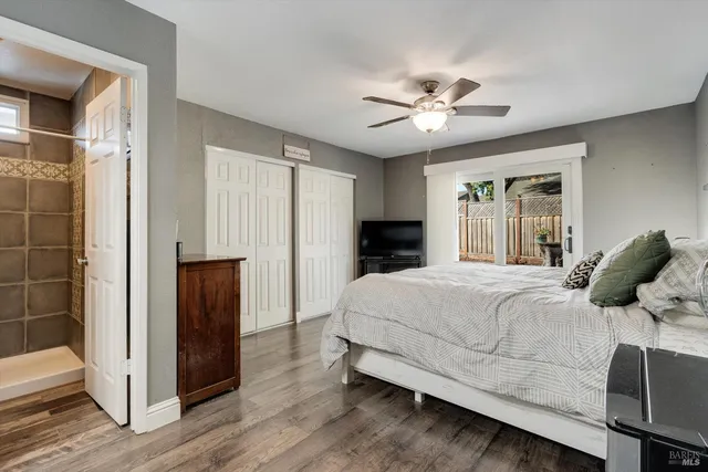 a bedroom with a large bed and a chandelier