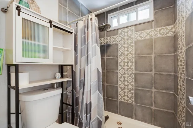 a bathroom with a shower and a sink