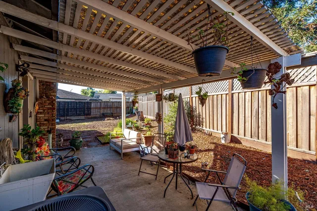 a living room with patio furniture and a wooden floor