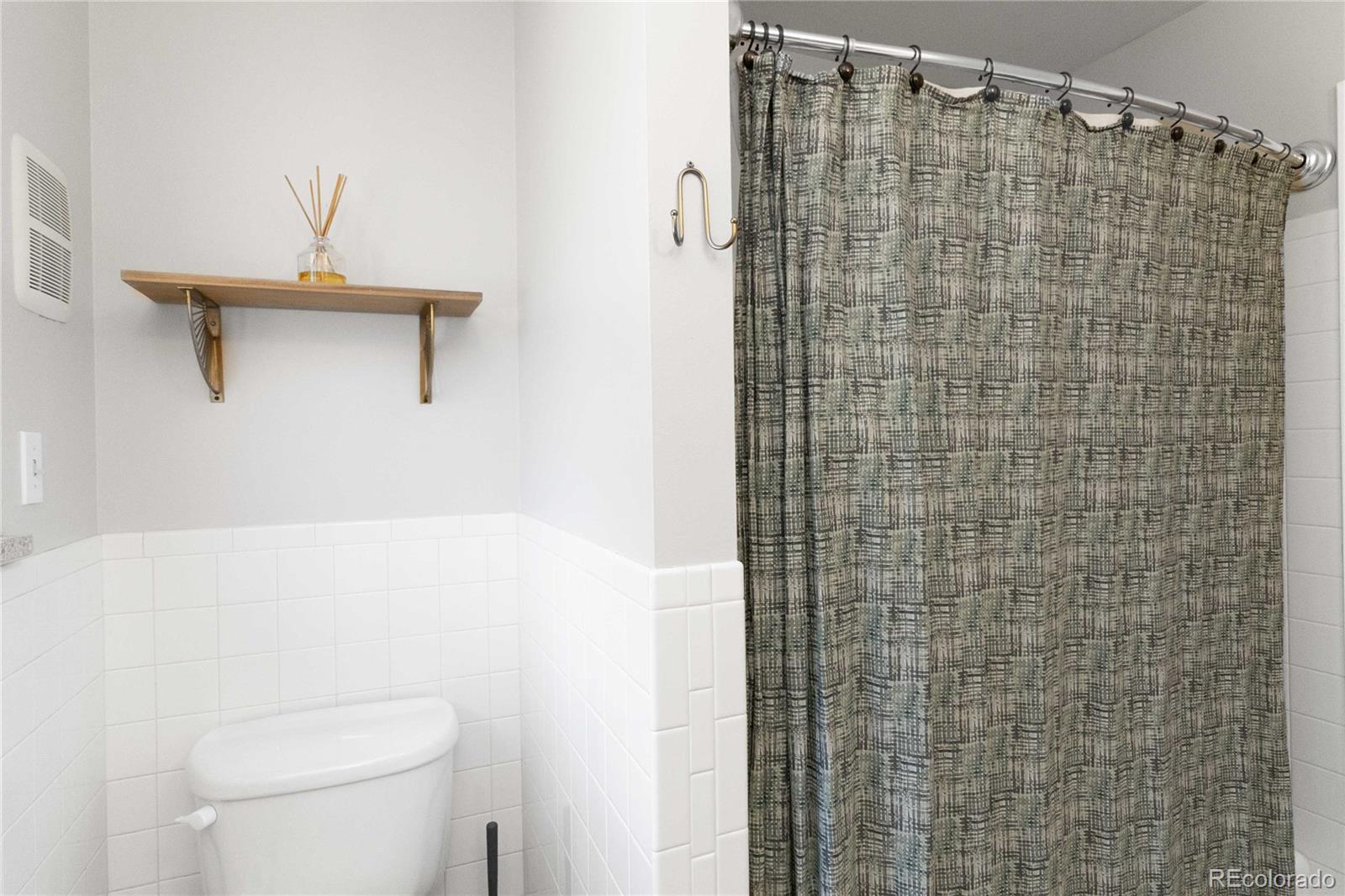 6984 Dover Way Arvada, CO 80004 - Photo 21 of 39 a bathroom with a shower and a toilet