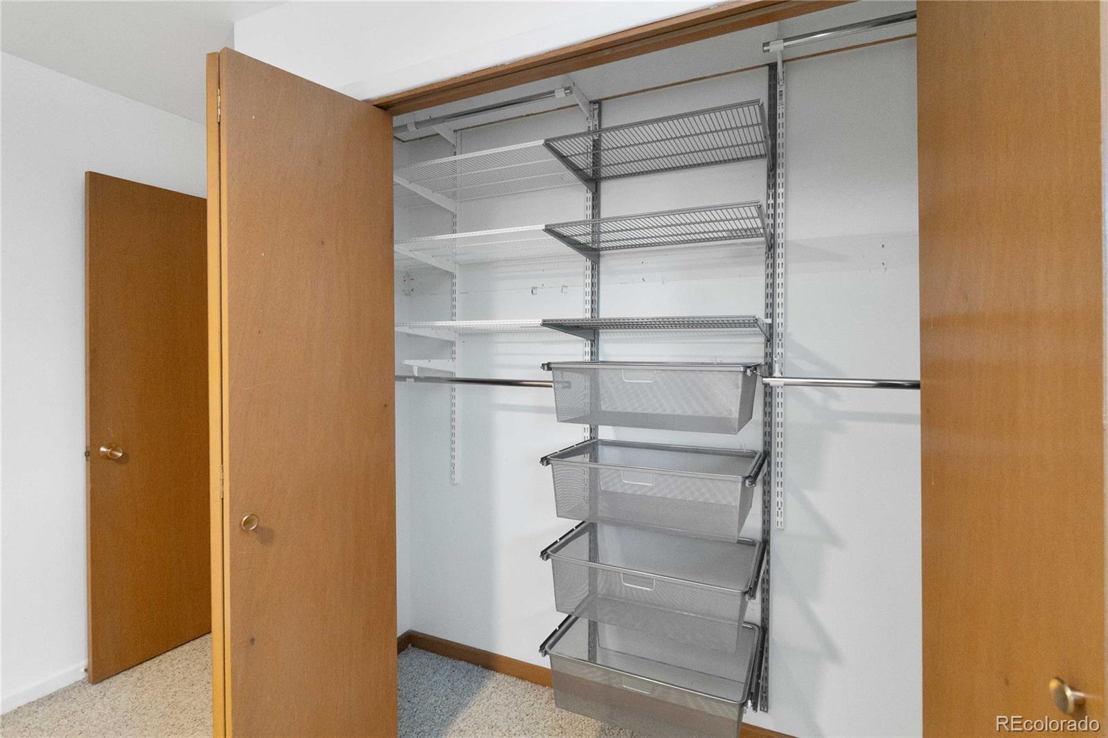 6984 Dover Way Arvada, CO 80004 - Photo 25 of 39 a view of walk in closet with empty racks