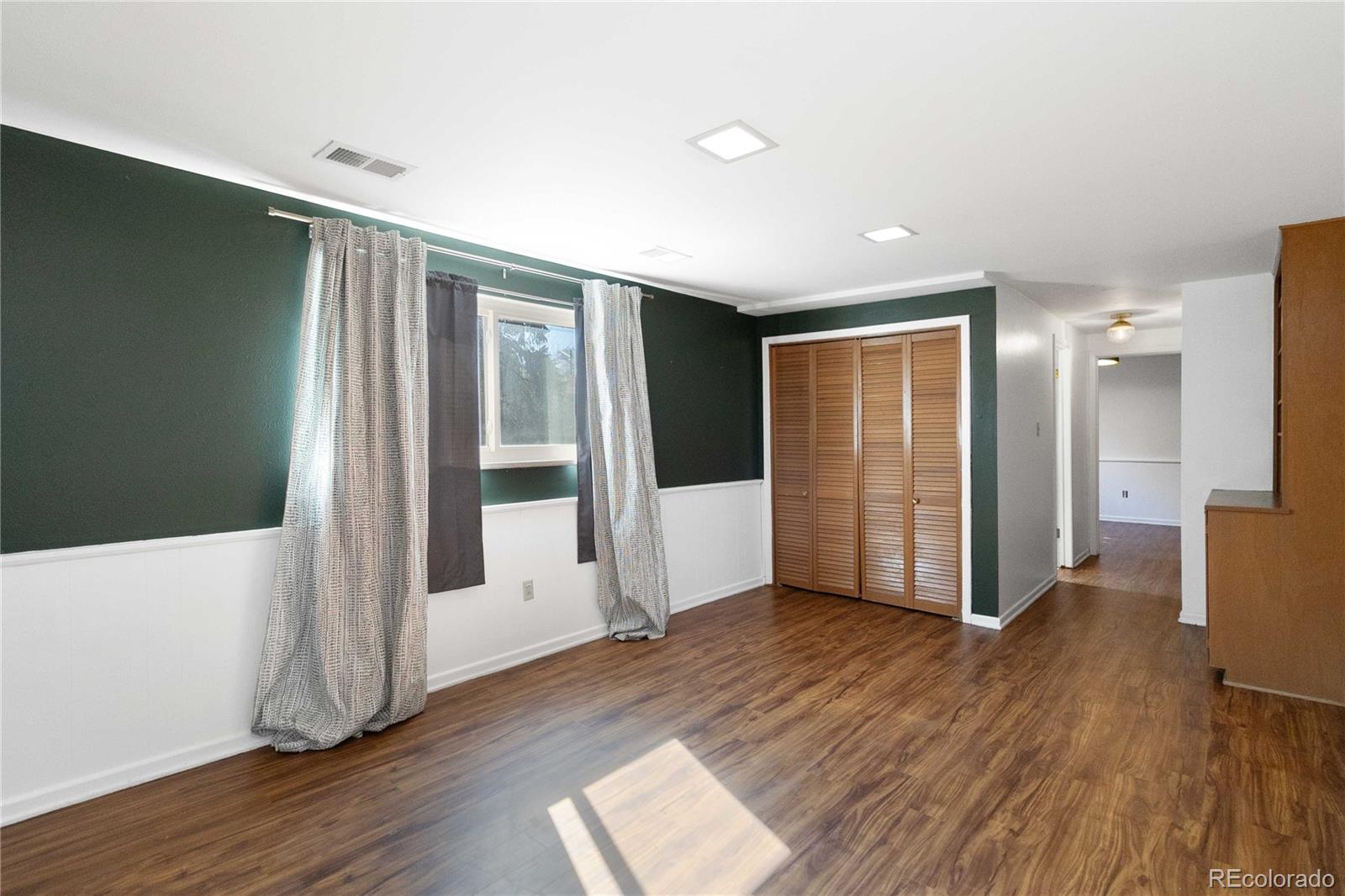 6984 Dover Way Arvada, CO 80004 - Photo 26 of 39 a view of wooden floor and windows in a room