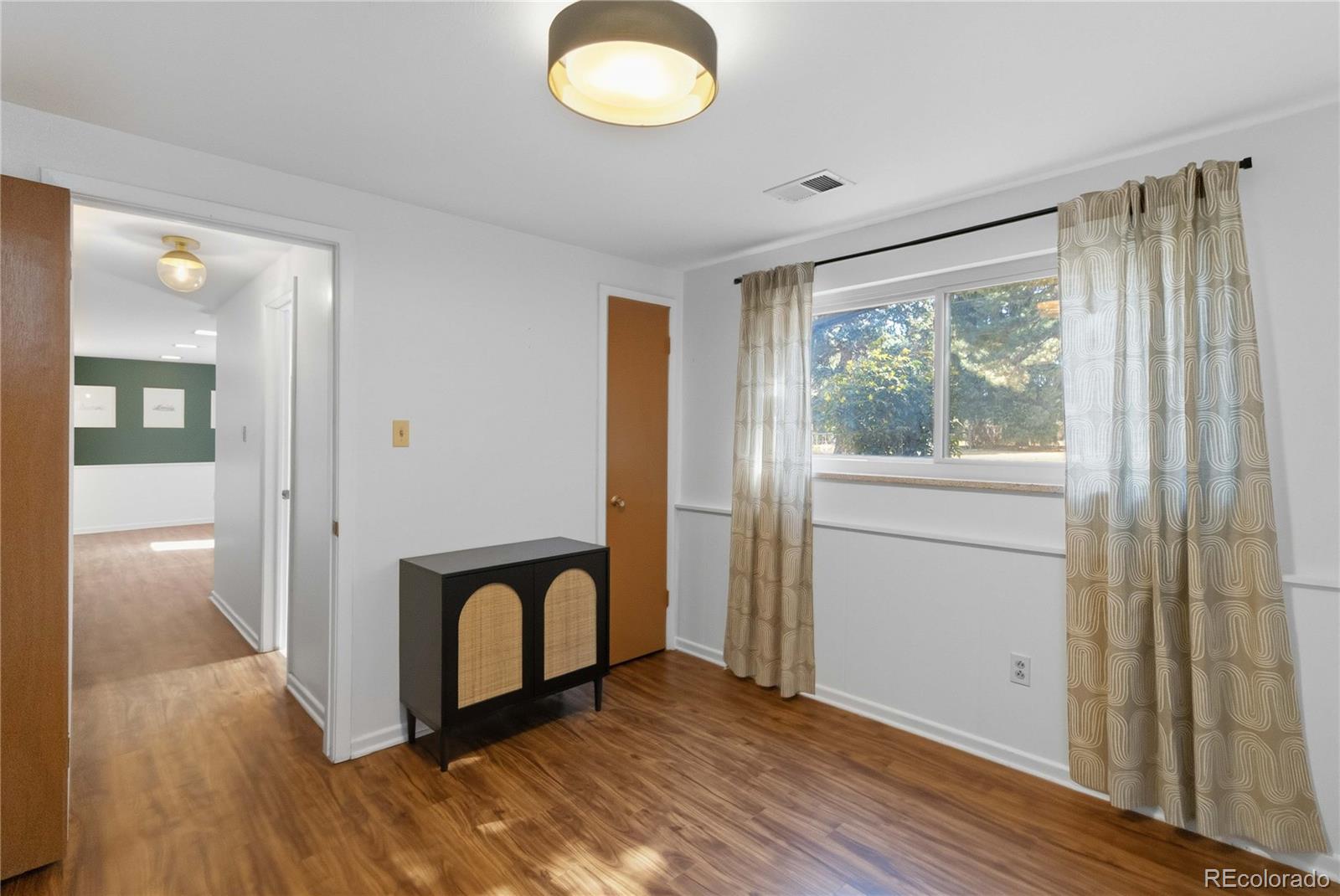6984 Dover Way Arvada, CO 80004 - Photo 30 of 39 a view of a room with wooden floor and windows
