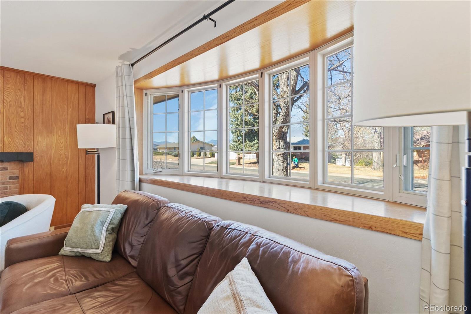 6984 Dover Way Arvada, CO 80004 - Photo 4 of 39 a living room with a large window and a bed