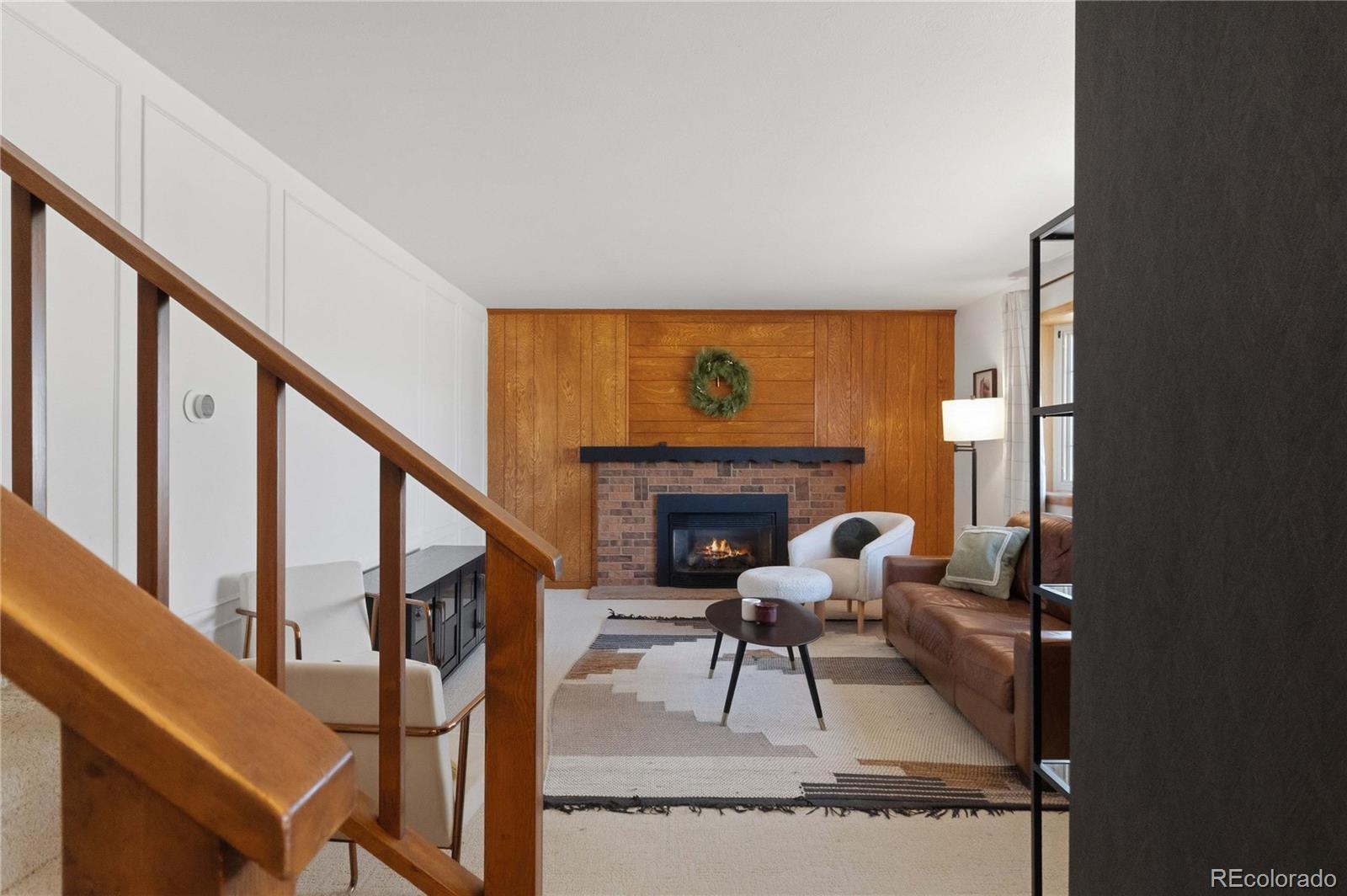 6984 Dover Way Arvada, CO 80004 - Photo 6 of 39 a living room with furniture and a fireplace