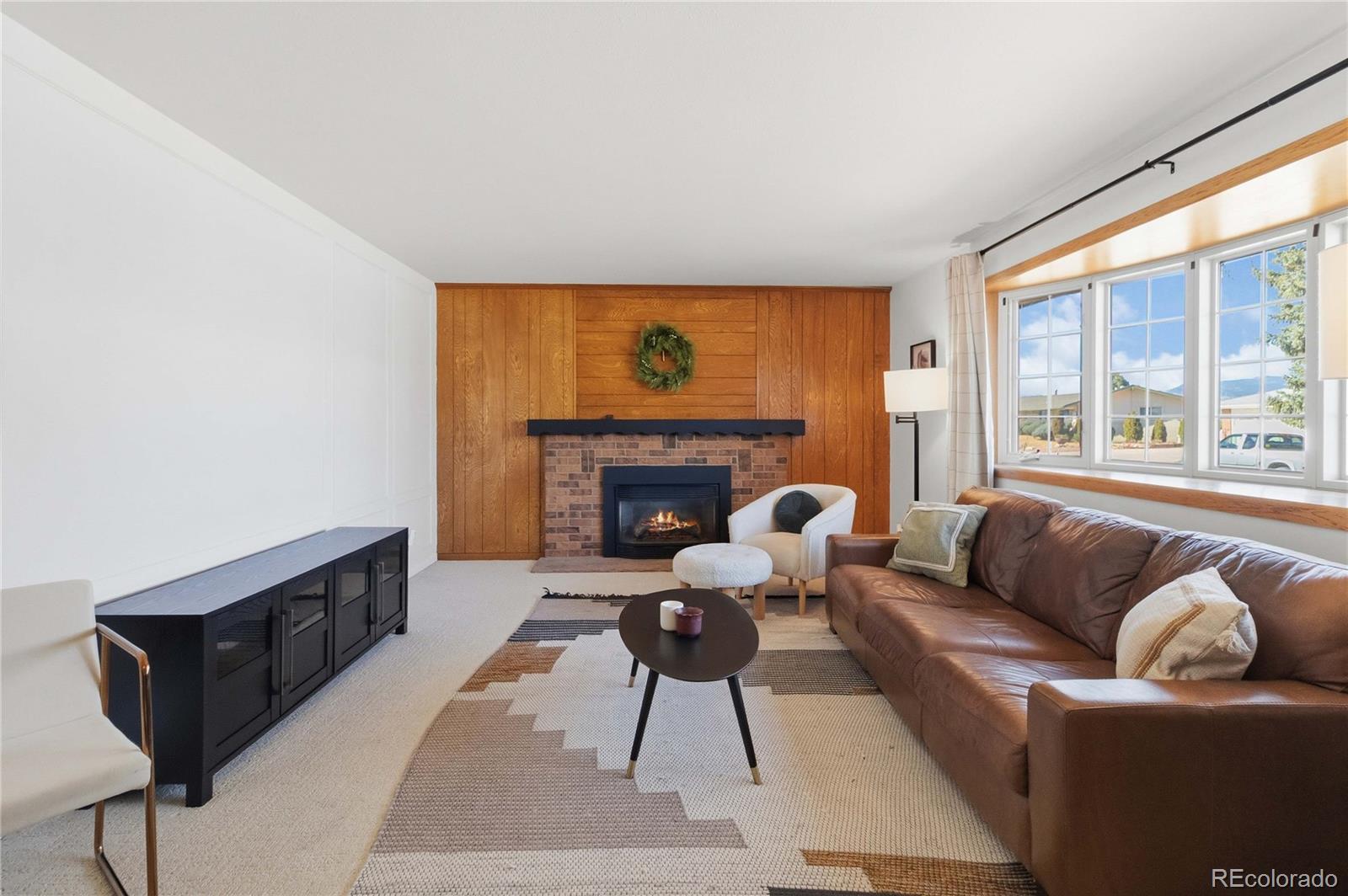 6984 Dover Way Arvada, CO 80004 - Photo 7 of 39 a living room with furniture and a fireplace