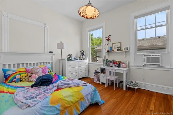 a bedroom with furniture and a wooden floor