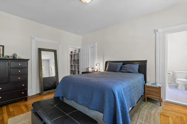 a bedroom with a bed and a dresser