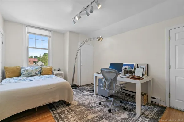 a bedroom with a bed and a desk