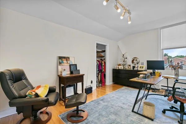 a livingroom with workspace and a couch