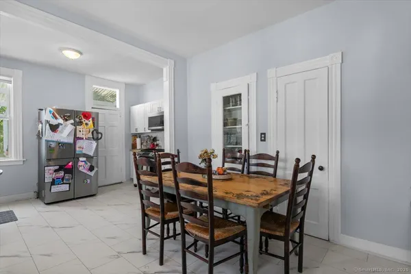 a view of a dining room with furniture and a window