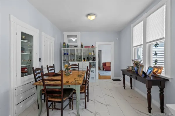 a view of a dining room with furniture and chandelier