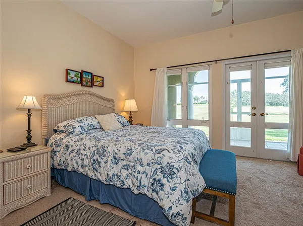 a bedroom with a large bed and a chair