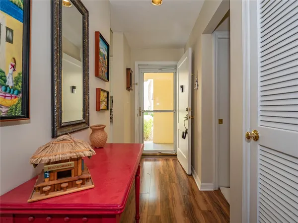 a view of a hallway with furniture and wooden floor