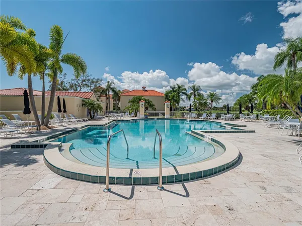 a view of a swimming pool with a table and chairs