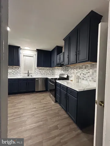 a kitchen with granite countertop a sink and cabinets