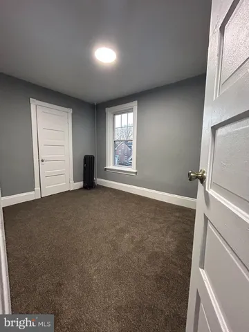 an empty room with closet area