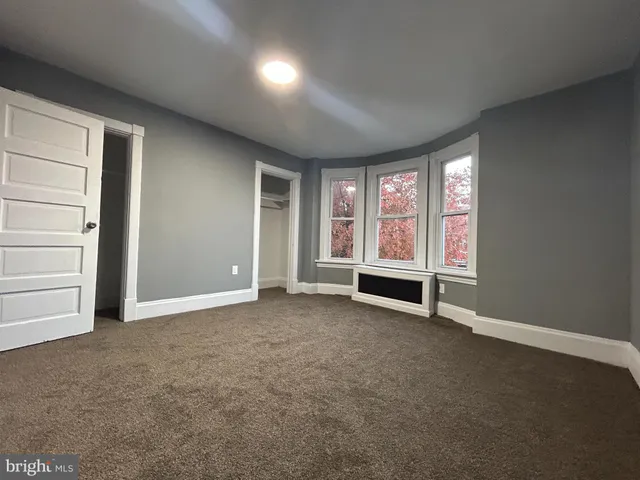 a view of hallway with wooden floor