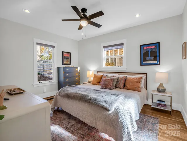a bedroom with a large bed and a chandelier