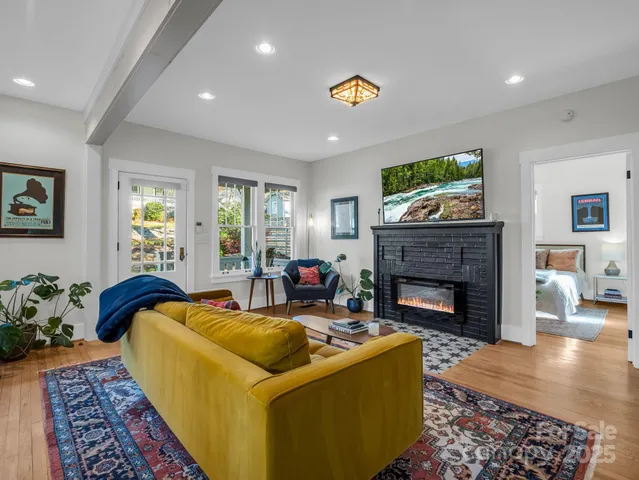 a living room with furniture and a fireplace