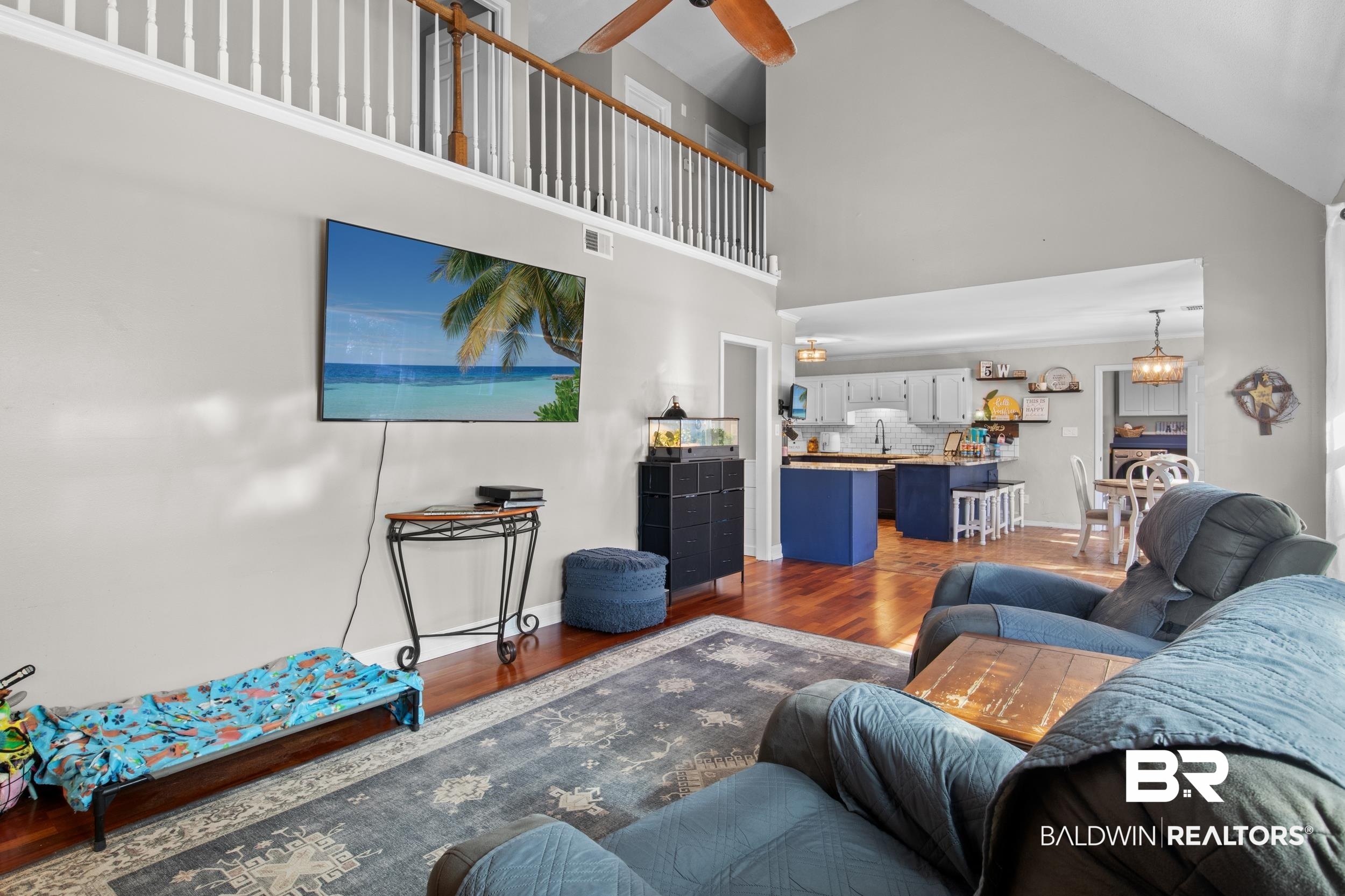 131 Marikesh Drive Daphne, AL 36526 - Photo 21 of 29 Living room featuring high vaulted ceiling, wood-type flooring, and ceiling fan with notable chandelier