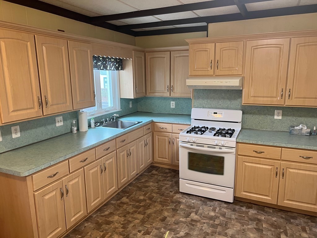 10 Guild Road Saugus, MA 01906 - Photo 3 of 7 a kitchen with granite countertop white cabinets and white appliances