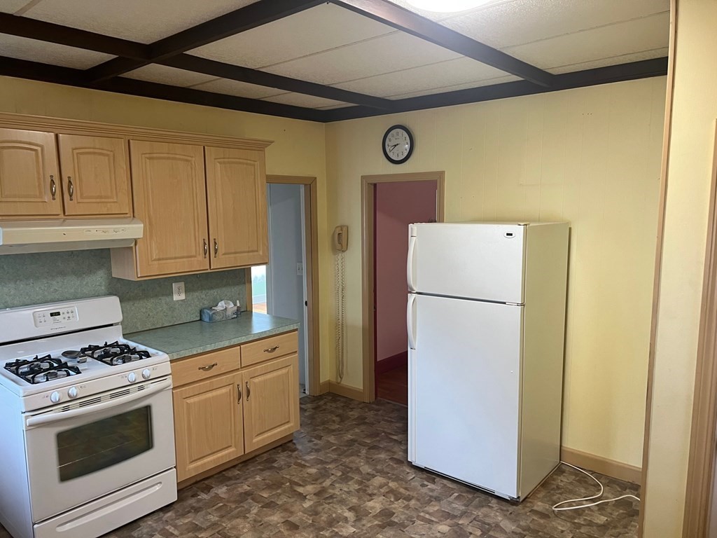 10 Guild Road Saugus, MA 01906 - Photo 4 of 7 a kitchen with a refrigerator sink stove and cabinets
