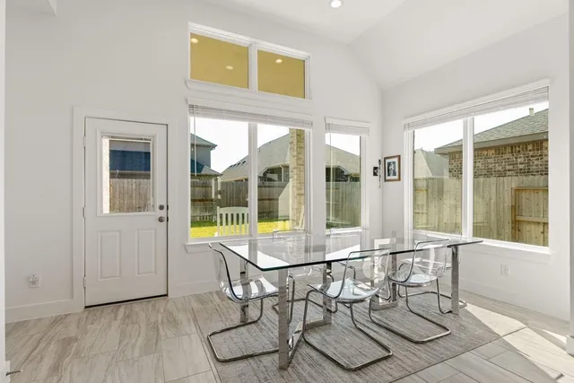 a view of a dining room with furniture large windows and wooden floor
