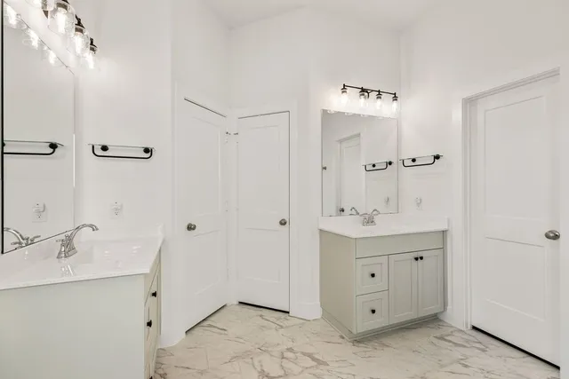 a spacious bathroom with a shower sink and mirror