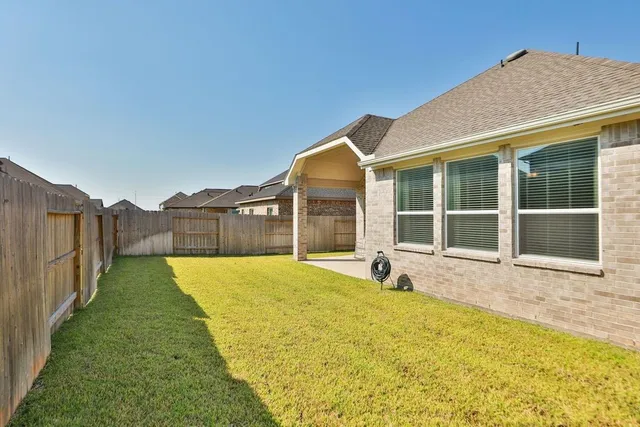 a view of a house with a garden and yard