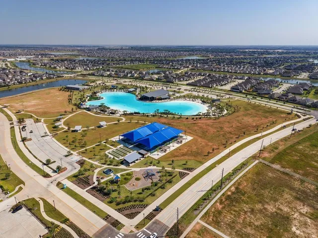 an aerial view of a residential building and an ocean