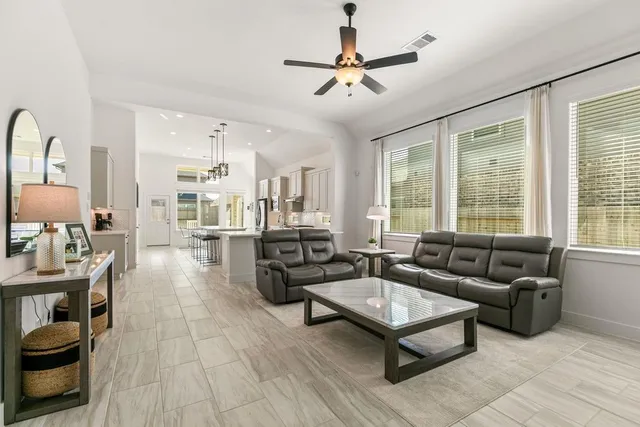 a living room with furniture and a large window