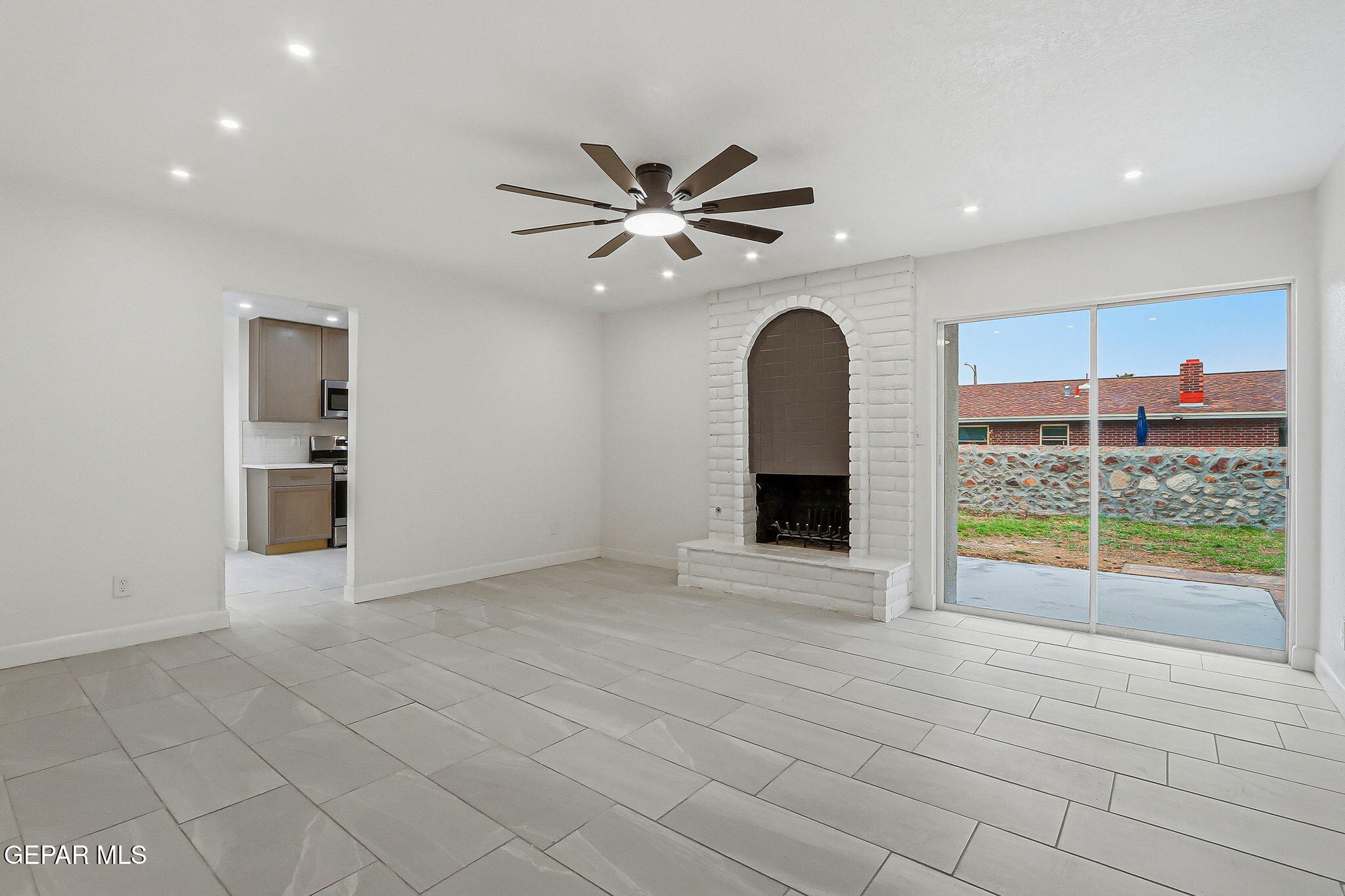 709 Frontera Road El Paso, TX 79922 - Photo 17 of 41 a view of an empty room with a ceiling fan and window